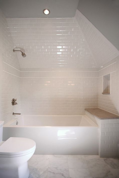 Amazing attic bathroom features glossy white bathtub tucked under dormer accented with white ... White Beveled Subway Tile, Built In Bathtub, Bathtub Tile, Attic Bathroom, Tub Surround, Attic Renovation, Transitional Bathroom, Shower Niche, Attic Remodel