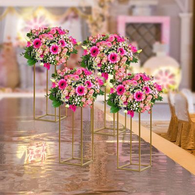 The simple column cube shape makes the flower stand more stable, so you need not worry about it will fall on your important occasions. Place the flower stand to add extra elegance to the party. | Mercer41 Cindel 4Pcs Gold Flower Floor Stand Metal Column Flower Stand Flower Arrangement Metal in Pink / Yellow | 23.6 H x 9.4 W x 9.4 D in | Wayfair Outdoor Wedding Backdrops, Metal Column, Geometric Centerpiece, Flower Floor, Stand Flower, Metal Columns, Cube Shape, Flower Stand, Metal Floor