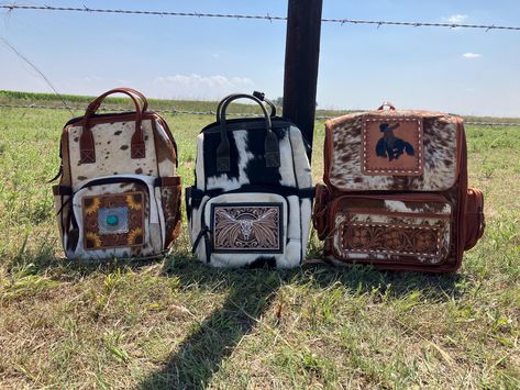 Genuine cowhide and leather on the longhorn, sunflower and bucking horse.  Adjustable shoulder straps.  Many zippered pockets Turquoise and Bucking Horse:  Measures:"16x13x6" Sunflower and Longhorn:  13.5x10x7.5 *Hide pattern will vary Western Baby Gift Basket, Western Diaper Bag, Western Backpack, Country Accessories, Western Nursery, Tool Backpack, Bucking Horse, Casual Country Outfits, Stanley Cups