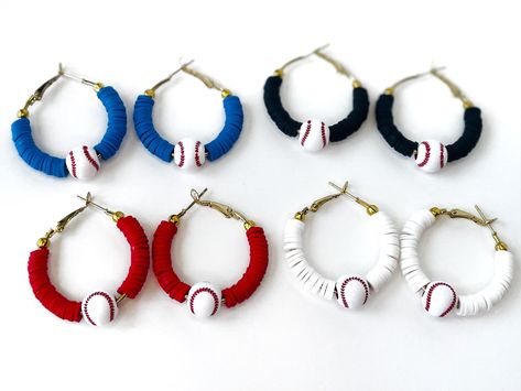 Support your team or your player in these stylish baseball hoop earrings! Baseball earrings are lightweight and the perfect size for all-day wear at the ball field.  All baseball hoops are 35mm (1 inch hoops) with heishi beads in the color of your choice and 1 acrylic baseball bead in the center. Earrings come with a lever-back closure on an 18k gold plated hoop earring. All hoops are nickel free and hypoallergenic. Materials:  - 18k gold plated hoop earrings (1 inch) - Clay heishi beads - Acrylic baseball bead Color: Please select your color choice from the drop down menu. Don't see your team's color? Message me to check availability. Bulk/Team Orders: For group or team discounts (Ex. one person ordering multiple pairs for an all-star team), please message me before purchase, and I can cr Diy Baseball Jewelry, How To Make Clay Bead Earrings, Baseball Polymer Clay Earrings, Brave Jewelry, Earrings Cricut, Heishi Jewelry, Sports Earrings, Jewelry School, Baseball Jewelry