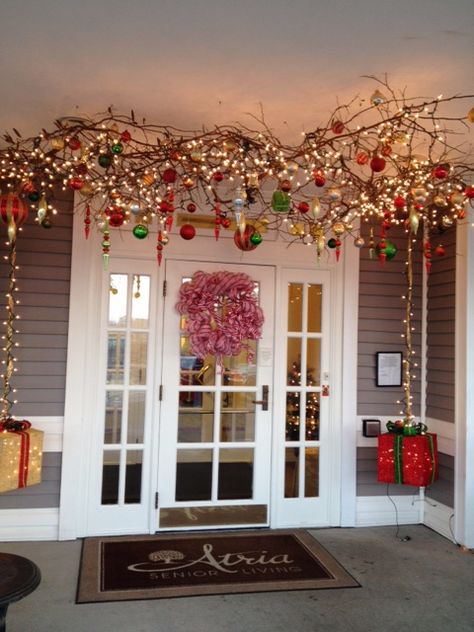 ....branches with lights and ornaments suspended from the ceiling.  This is an outdoor entryway.  (During the fall, pumpkins, etc. were hanging from the branches.) Branches With Lights, Christmas Ceiling Decorations Ideas, Christmas Ceiling Decorations, Christmas Branches, Hanging Christmas Lights, Candy Land Christmas Decorations, Christmas Hanging Decorations, Candyland Decorations, Christmas Porch