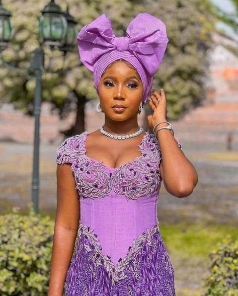 Latest, Mind-blowing Asoebi styles that would blow your mind Lilac Lace Gown Styles Aso Ebi, Lilac Lace Asoebi Styles, Robe Dote, Corset Asoebi Styles, Lace Gown Styles Aso Ebi, Ankara Asoebi Styles, Owanbe Styles, Ankara Asoebi, Lace Asoebi Styles