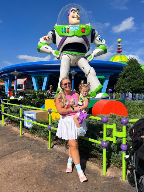 Nicki Odom in pink tank top and white skirt with 3T toddler in buzz light year dress and ears at Hollywood Studios in Disney World Hollywood Studios Family Outfits, Disney Mom Outfit, Family Disney Outfits, Outfits For Disney, Disney Family Outfits, Disney Outfit Ideas, Disney World Hollywood Studios, Outfit Disney, Styled Outfits