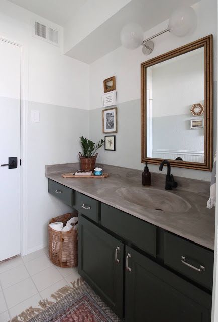 I redid our bathroom with a few purchased pieces and a whole bunch of diy. You can make the best of a space by working with what you've got! | House Homemade Concrete Countertops Bathroom, Master Bath Renovation, New Paint Colors, Bamboo Mirror, Bath Renovation, Concrete Counter, Green Cabinets, Bathroom Countertops, Bathroom Redo