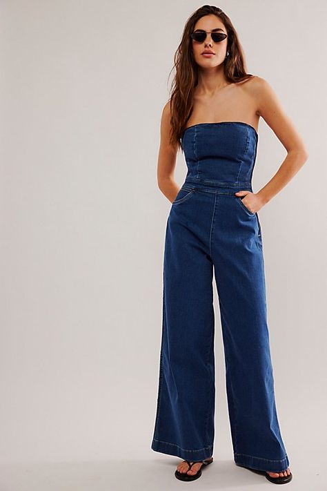 Forever timeless with a femme touch, this jumpsuit from Wrangler is the perfect done-in-one instant outfit. **Fit:** Slim, corset-inspired bodice with wide-leg fit **Features:** Strapless design, side zip closure, smocked back for ease, soft stretch denim **Why We ❤ It:** Sleek with fun platforms or off-duty with sporty sneakers, this pair has endless ways to wear. | Wrangler Corset Playsuit at Free People in Dark Wash, Size: M Strapless Jumpsuit Outfit, Playsuits Outfit, Sporty Sneakers, Jumpsuit Outfit, Strapless Jumpsuit, Embellished Jeans, Jumpsuit Fashion, Jeans Jumpsuit, Denim Jumpsuit