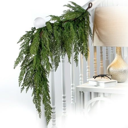 Get the real feel of Christmas with this perfect 48" Lebanon Cedar Full Garland. Crafted of real-touch plastic in natural green hues. Perfect for hanging on stairways, banisters, trees, and even windows. Try adding ornaments, birds, and flowers for an exciting addition. Suitable for indoor and outdoor use. Hanging loop is attached for a seamless display. Product ships compressed and may require additional primping to match the image shown. Blow with canned air for cleaning. Cedar Swag, Christmas Garland On Stairs, Lebanon Cedar, Window Garland, Cedar Garland, Artificial Christmas Garland, Christmas Garlands, Christmas Fireplace Decor, Pine Garland