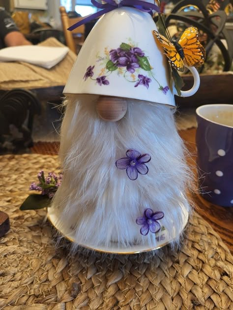 Tea cup gnome. Request for violets.  Her husband passed ..si I added a 🦋 Teacup Gnomes Diy, Teacup Gnomes, Tea Cup Gnomes, Recycled Christmas Decorations, Cup And Saucer Crafts, Teapot Crafts, Gnome Crafts, Teacup Crafts, Deco Mesh Wreaths Diy