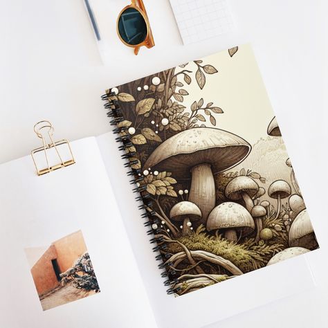 🍄✨ Unveiling the charm of our latest creation: Mushroom Notebooks! 📔🌿 Perfect for jotting down thoughts, sketches, or your next big idea! 🖊️📖 #Mushrooms #TMC28 #ItsYourChoice Woodland Scene, School Notes, Lined Page, Blank Book, Book Journal, Paper Weights, Cover Design, Gift Shop, Music Book