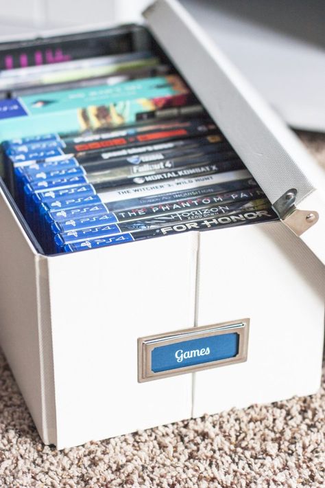 Love this organizing solution for a tv stand! Organize video games and all of the accessories inside pretty storage boxes. These Pop 'N Boxes are so cool because they look nice and fold flat when not used. I love how this blogger added bookplate labels to them! That painted TV stand plus the storage boxes made such an improvement! Painted Tv Stand, Video Game Organization, Pretty Storage Boxes, Video Game Storage, Kids Storage Boxes, Swivel Tv Stand, Cd Storage, Pretty Storage, Diy Tv Stand