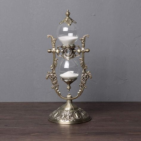 Delicate but gorgeous. Well well. what a glittering assemblage.. Perfect goth and alt home furnishings and decor 🕸️🕸️ #HalloweenForever Sand Hourglass, Hourglass Sand Timer, Hourglass Timer, Time Timer, Sand Clock, Living Room Tv Cabinet, Hourglasses, Sand Timers, Office Desk Decor