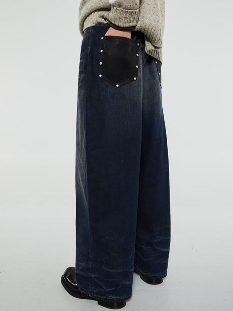 Cut to a super baggy loose fit, these jeans feature a mid-waist, super wide leg, and long length for a relaxed look. Crafted from non-stretch denim in a dark blue wash, with added details like contrast leather pockets and a logo patch on the back.