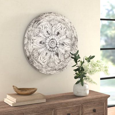 Fusing traditional elegance with rustic design elements, this 28" H x 28'' W piece of wall decor is crafted from pine wood, features a sunburst-inspired medallion pattern in a weathered white hue. Its floral design is perfect for both traditional homes and country cottages. Set it atop your front door in the foyer for a stylish centerpiece, or add it to the master suite above your dresser for a fun display. | Three Posts™ Medallion Wooden Wall Decor in Black/Brown/Gray, Size 28.0 H x 28.0 W x 3. Wall Medallion, Country Cottages, Iron Wall Sconces, Entryway Wall Decor, Traditional Homes, Modern Framed Art, Weathered White, Medallion Pattern, Decorative Sculpture