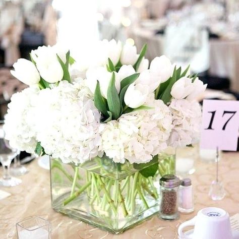 All white centerpiece with hydrangea and tulips Tulip Centerpieces Wedding, Wedding Centerpieces White, White Hydrangea Centerpieces, Tulip Centerpiece, White Wedding Centerpieces, Tulip Wedding, Tall Wedding Centerpieces, Hydrangea Centerpiece, White Centerpiece