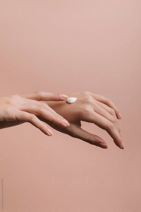 Woman rubbing moisturizer on her hands on a pink background. #hand #woman #skin #cream #moisturizer #beautycare #delicate #touch #female #minimal #pink #nude Cream Moisturizer, Skin Cream, Pink Background, Beauty Care, Hands On, Royalty Free Stock Photos, Moisturizer, How To Apply, Cream