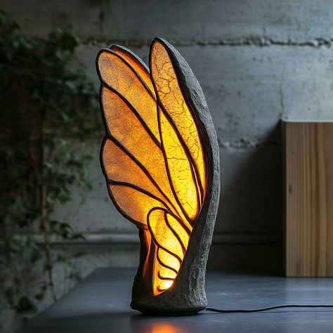 This lamp, inspired by the delicate structure of insect wings, brings a touch of nature’s elegance into your home. The lampshade mimics the intricate patterns found in the wings of dragonflies or butterflies, with translucent panels that softly diffuse light, creating a warm and inviting glow. The design features a lightweight, airy frame that captures the fragility and grace of the natural world, while the lamp’s organic curves and subtle textures evoke the sense of being surrounded by natur... Foldable Ideas, Cool Sculptures, Unique Pic, Neon Decorations, Butterfly Lamp, Lamp Inspired, Insect Wings, Neon Decor, Tree Lamp