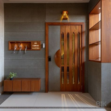 Apartment Interior Is Amalgamation Of Earthy Tones And Greys | BplusK Architects - The Architects Diary Safty Door Design Entrance Wooden, Main Door With Jali Design, Safty Door Designs, Front Main Door Designs, Safty Door Wooden Design, Safty Door Design Front Entry, Modern Doors Exterior Entrance, Apartment Flat Entrance Design, Entrance Design Interior