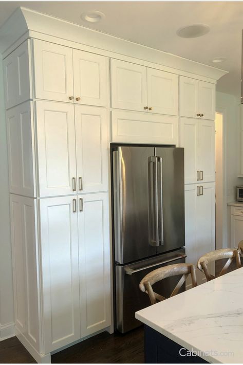 With crown molding and stacked cabinets, these homeowners transformed their basic refrigerator into a swoon-worthy built-in. White Shaker Kitchen Cabinets Hardware, Shaker Cabinet Door Styles, Crown Moulding Kitchen Cabinets, Stacked Cabinets, Cabnits Kitchen, Shaker Cabinets Kitchen, Kitchen Cabinet Molding, Crown Molding Kitchen, Kitchen Cabinet Crown Molding