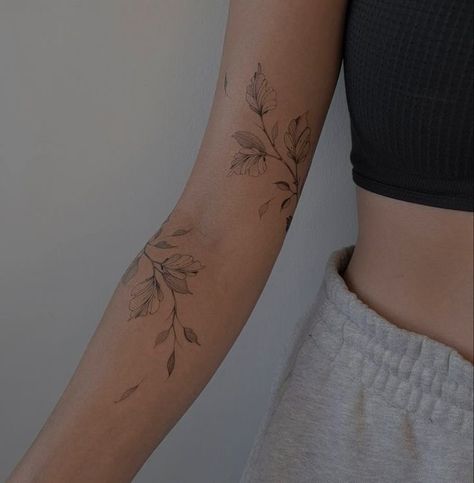 Tattoos Wrist Wrap Around, Around The Arm Flower Tattoo, Womens Family Tattoos, Floral Leaf Wrap Tattoo, Marigold Wrap Around Tattoo, Floral Shoulder Cap Tattoo Fine Line, Dainty Vine Tattoo Arm, Floral Biblical Tattoo, Unique Wrap Around Tattoo