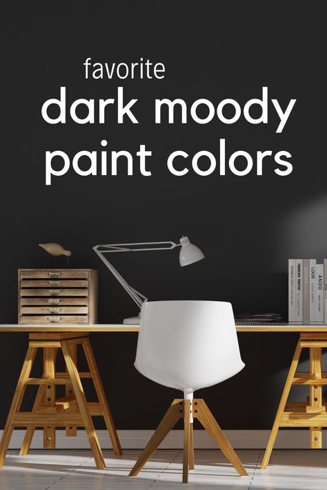 A wood desk with a white chair in front of a dark black moody painted wall Dark Moody Paint Colors Benjamin Moore, Best Dark Wall Colors, Moody Dining Room Paint Colors, Sherwin Williams Moody Colors, Moody Wall Color, Dark Moody Paint Colors, Moody Paint Colors, Moody Paint, Dark Paint Colors