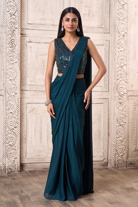 Teal blue pre-draped saree paired with sleeveless padded blouse. Comes with embroidered belt. Component: 3 Pattern: Embroidered Type Of Work: Geometric Neckline: Blunt V Neck Sleeve Type: Sleeveless Fabric: Chinnon Color: Blue Other Details:  Embroidered blouse Occasion: Wedding - Aza Fashions Saree With Sleeveless Blouse, Best Designer Sarees, Draped Saree, Purple Saree, Indian Designer Sarees, Sarees For Women, India Fashion Week, Designer Sarees Collection, Latest Designer Sarees