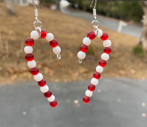 "These will be great for the Christmas holiday! Cute sea glass Christmas candy canes. Perfect little gift for someone or a stocking stuffer. Fantastic earrings for the holiday! These are 2\"  long. Earring hooks are .925 sterling silver. These will be wrapped in tissue paper, put in a box and mailed First Class in a bubble mailer. Please note: If you are outside of the US, shipping can take up to 3-6 weeks to get to you... maybe a little longer, especially during the holidays.  Be sure to check out all of my other designs and colors, using this link: https://www.etsy.com/shop/SmithNJewels?ref=seller-platform-mcnav§ion_id=27417665" Sea Glass Candy, Candy Cane Earrings, Sea Glass Christmas, Christmas Candy Canes, Beaded Jewelry Earrings, Cheap Christmas Gifts, Long Earring, Christmas Bead, Holiday Candy