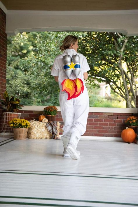 Dreaming of leaving this world behind and laying down roots on Mars? We relate. This last-minute DIY Astronaut costume isn’t quite space-ready, but it’s certainly fit for your upcoming Halloween festivities here on Earth. Build your jet pack with two recycled 2-liter bottles painted metallic silver, and add blue-and-white stripes for a quintessential rocket appeal. Ready for blast-off? Glue red, yellow and orange felt flames to the base of your jetpack to take off and fly into the night. Diy Astronaut Costume, Astronaut Diy, Astronaut Halloween Costume, Outer Space Costume, Astronaut Halloween, Alien Halloween Costume, Handmade Halloween Costumes, Space Costumes, Kostum Halloween