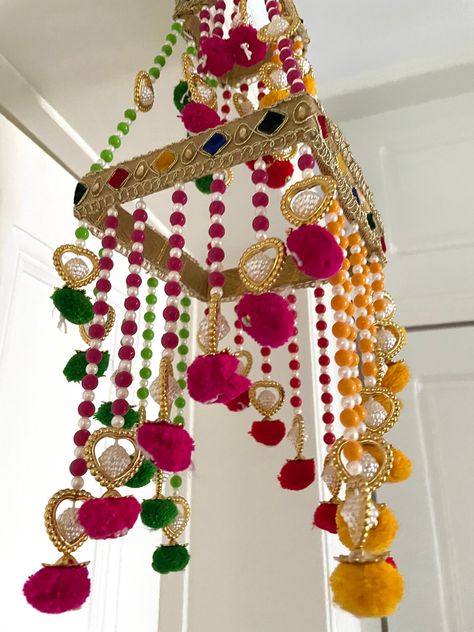 Jhoomar - Decoration Measurements * all measurements are approx * Drop 40-45 cm Key Chain rings for easy hassle-free hanging Display these beauties on your Front door, office, puja rooms to welcome Goddess Lakshmi. During weddings and baby showers as-well these decorations are used to welcome guests and the new members to the family. We often put videos and more images of these items on our Instagram page, please have a look https://www.instagram.com/tohfaa_london/ *Combined postage we only char Janmastami Decorations, Diwali Hangings, Royal Home Decor, Toran Designs, Hanging Decorations Diy, Modern Decorations, Wool Crafts Diy, Seashell Art Diy, Garden Rack