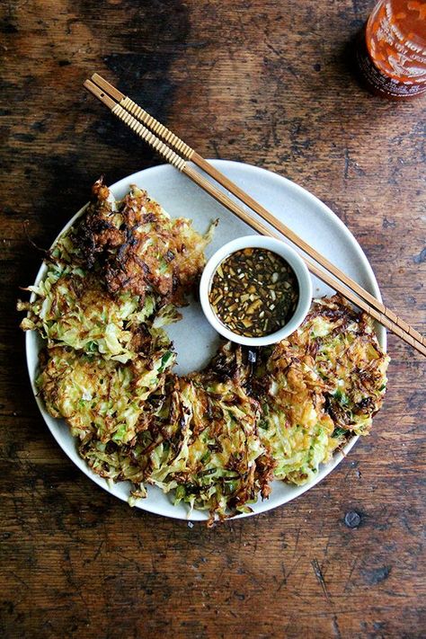 Okonomiyaki, Japanese cabbage pancakes, can be made in countless ways: okonomiyaki essentially means prepared as you like. This my favorite version I've made yet, but know that you can add to it as you like with shrimp or chicken, sesame seeds or bonito flakes, other vegetables, etc. I prefer a soy-based dipping sauce to the more traditional mayonnaise-based, and, like the corn fritters, find these as irresistible freshly fried as cold straight from the fridge. // alexandracooks.com Cabbage Pancakes, Japanese Cabbage, Chinese Kool, Vegetarian Cabbage, Food 52, Chopsticks, Good Eats, Asian Recipes, Diner