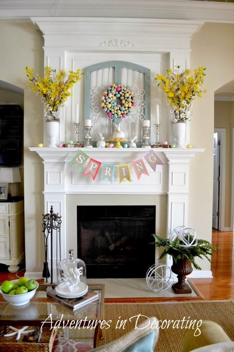 Spring mantle with a spring banner, yellow flowers, candles and decorative rabbits. Spring Mantel Decorating Ideas, Easter Mantle, Diy Osterschmuck, Spring Mantle, Diy Ostern, Mantel Decor, Spring Holidays, Spring Easter Decor, Easter Time