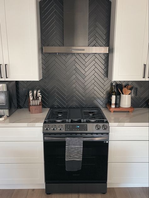 Matte black herringbone kitchen backsplash, white shaker cabinets. Black Stacked Backsplash, Black Matte Backsplash Kitchen, Black Backsplash Black Grout, White Subway Tile Kitchen Backsplash With Black Accent, White Cabinets Kitchen Black Backsplash, Black Matte Backsplash, Matte Black Herringbone Backsplash, White Countertop Black Backsplash, Black Kitchen White Backsplash