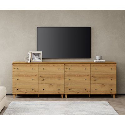 This 12-drawer TV dresser goes well with your bedroom, living room, or anywhere needs to be organized and stored. Each cabinet is equipped with an anti-tip kit which makes it perfect for households with children. Color: Oak Brown | Wade Logan® Bonis TV Stand for TVs up to 88" Wood in Brown | 32.4 H x 94.4 W x 15.3 D in | Wayfair Living Room With Dresser, Tv Dresser Living Room, Extra Long Dresser Bedroom, 2 Dressers Side By Side, Dresser Tv Stand Bedroom, Long Dressers Bedroom, Bedroom Dresser With Tv, Bedroom Tv Stand Ideas, Dresser Under Tv