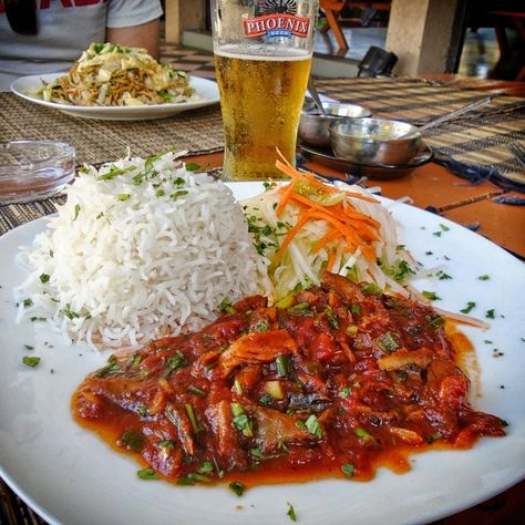 Salted Fish Rougaille, served with rice and salad at a local restaurant in Trou-aux-Biches, Mauritius. And let's not forget the Phoenix beer! Sausage Creole, Mauritius Food, Mauritian Food, Salted Fish, Best Place To Visit, Spice Combinations, Tomato Dishes, 4k Pictures, National Dish