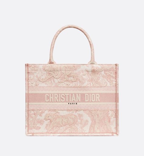 Introduced by Maria Grazia Chiuri, Creative Director of Christian Dior, the Dior Book Tote has become a staple of the Dior aesthetic. Designed to hold all the daily essentials, the style is fully embroidered with the ecru and pink Toile de Jouy motif. Adorned with the Christian Dior Paris signature on the front, the medium tote exemplifies the House's signature savoir-faire and may be carried by hand or worn over the shoulder. Christian Dior Bag, Dior Aesthetic, Dior Book, Christian Dior Paris, Sacs Design, Dior Paris, Luxury Bags Collection, Dior Book Tote, Maria Grazia Chiuri