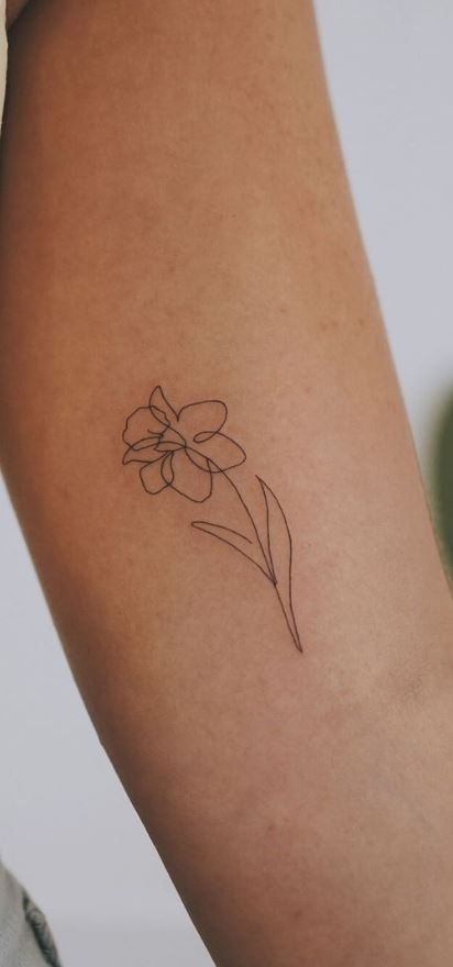 Small Line Art Flower Tattoos, Ankle Daffodil Tattoo, Gerber Daisy Tattoo Designs, Linework Daffodil Tattoo, Minimalist Dafodill Tattoo, Matching Daffodil Tattoos, Jan Flower Tattoo, Simplistic Daffodil Tattoo, Daffodil Sketch Tattoo