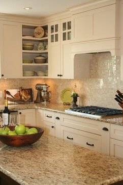 The stark white of these cabinets is dressed up just a little with the darker colors in the countertops. It definitely helps create something unique and stylish to counter bland and boring. Cream Colored Kitchens, Cream Colored Kitchen Cabinets, Ideas Decorar Habitacion, Cream Kitchen Cabinets, Backsplash For White Cabinets, Refacing Kitchen Cabinets, Santa Cecilia, Kitchen Backsplash Designs, Granite Countertops Kitchen