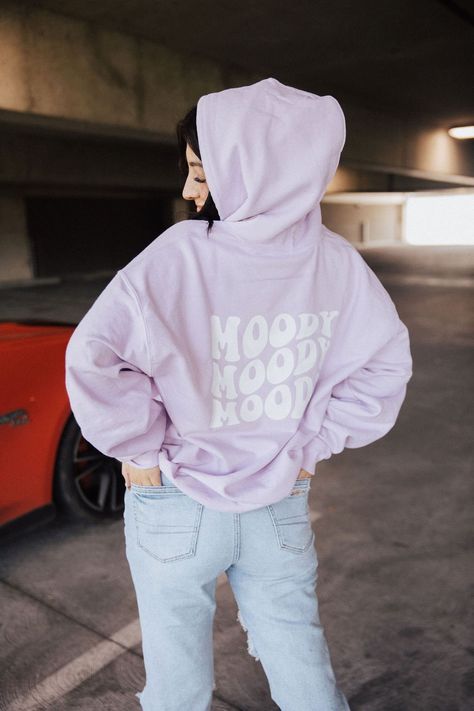 Unisex fit lilac hoodie with a white MOODY design on the back and a white smiley on the front. Please choose correct unisex size.  Apparel Care instructions: Turn apparel inside out to wash, machine wash cold, avoid fabric softeners, do not bleach, do not iron, dry on low heat.   Instagram @mati.made  Facebook MatiMade Hoodie Poses Instagram At Home, Lilac Hoodie, Graphic Tees Trendy, Parking Garage Photoshoot, Garage Photoshoot, Moody Design, Country Tees, Trendy Hoodies, Coffee Tees