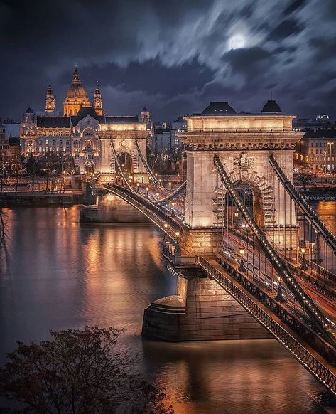 The Széchenyi Chain Bridge is a chain bridge that spans the River Danube between Buda and Pest, the western and eastern sides of Budapest, the capital of Hungary. Designed by English engineer William Tierney Clark and built by Scottish engineer Adam Clark, it was the first permanent bridge across the Danube in Hungary. It was opened in 1849. 🇭🇺 Gresham Palace, Capital Of Hungary, Best Places In Europe, Budapest Travel, Europe Photos, Voyage Europe, Places In Europe, Visiting Greece, Visit Europe