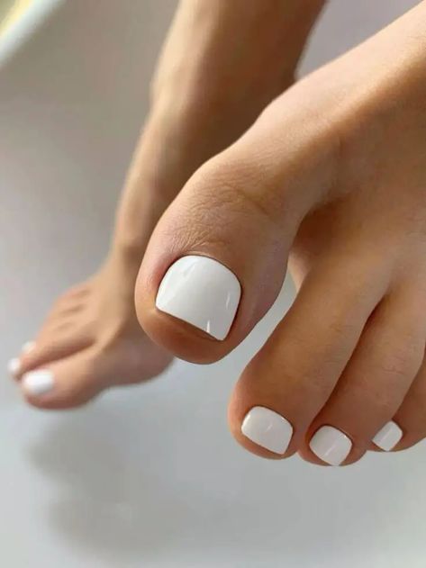 Discover the latest trends in spring toe nail colors for 2024, perfect for fashion-forward women aged 25-55. This guide showcases stylish pedicure ideas, from matte mauves and sparkling pastels to bold ombre and solid tangerine hues. Embrace 2024's gel polish, dip powder, and acrylic options for a fresh, bright look. Find your next pedicure inspiration with almond, neon, and multi-colored trends that promise to elevate your style and make a statement this season. Whether you prefer light pastels Spring Toe Nail Colors, Pedicure Inspiration, Wedding Toe Nails, Toe Nail Colors, White Pedicure, Rounded Acrylic Nails, Colors For 2024, Fake Nail Tips, Pedicure Colors