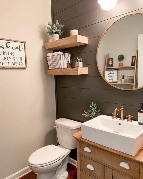 A moody earth-toned green wall paint covers the rustic shiplap paneling in this modern farmhouse half bath. A gold framed mirror, faucet, and shelf decor add some varying metallic colors and textures. Indoor plants are a great added pop of color and organic element in a space like this...   Image: foreveryoungfarmhouse Half Bath Wall Paneling, Decorating Airbnb, Modern Farmhouse Half Bath, Shiplap Wall Bathroom, Modern Half Bathroom, Farmhouse Half Bath, Bathroom Accent Wall Ideas, Modern Half Bath, Earth Tone Bathroom