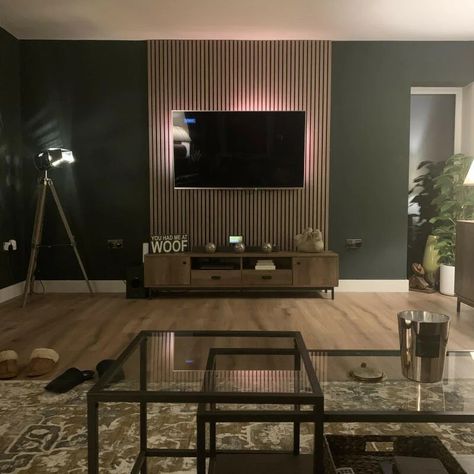 Wooden Panel Behind Tv, Lounge Slat Wall, Living Room Slats, Slat Feature Wall Living Room, Tv On Paneled Wall, Tv Panelling Ideas, Living Room Decor With Paneling, Paneling Around Tv, Dark Wall With Wood Slats