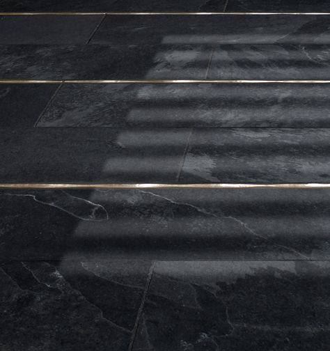 traditional bronze liner accent black stone floor McQueen - Lowitz & Company Dark Stone Floor, Black Stone Floor, Marble Inlay Floor, Ceramic Tile Floor Bathroom, Ceramic Floor Tiles Living Room, Black Marble Floor, Club 33, Ceramic Tile Colors, Tile Floor Living Room