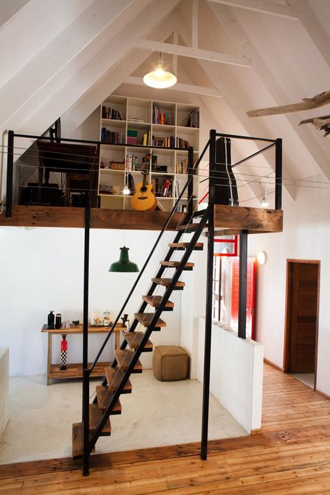 The mezzanine level makes the perfect study nook. Mezzanine Study Area, Mezzanine Library Bookshelves, Stairs To Mezzanine, Bungalow Mezzanine, Narrow Loft Ideas, Mezzanine Stairs Ideas, Mezannine Loft Interior Design, Altillos Ideas, Loft Staircase Ideas