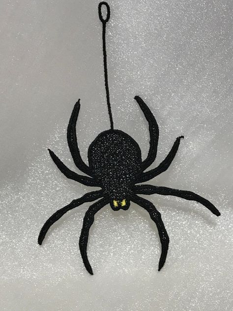 "Hanging Spider is made from Free Standing Lace and measures approximately 6.95\"(w) X 4.87\"(h and comes with a satin ribbon for tying. )Makes a  great decoration, can be given as a gift or used as an applique. Shown in Black with Bright Yellow for eyes.  Other color choices are available. Please see photo 2 for custom colors offered by 1962 Company.  Please state color choices in  the personalization section below. Also available without the string, see Big Lace Spider listed in our shop All o Hanging Spider, Embroidery Product, Free Standing Lace, For Eyes, Bright Yellow, A Design, Embroidery Art, Design Files, Satin Ribbon