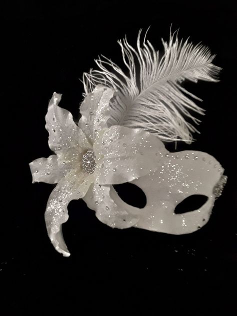 Masquerade Mask , Bridal Mask, Wedding Photo Prop, Ballroom Mask, Mardi Gras, Handmade Mask Handmade one of a kind paper mache mask. Covered with white bridal satin fabric then embellished with clear glitter that adds a sparkle as you walk across the room. I added a large white lilly on right side of mask which is adorned with large crystales and matching glitter. I followed across top of mask with large matching crystals which meet with a large rhinestone brooch in the form of flowers. Tucked b Ballroom Mask, Masquerade Aesthetic, White Masquerade Mask, Silver Masquerade Mask, Wedding Photo Prop, Masquerade Ball Mask, Paper Mache Mask, Bridal Mask, Handmade Mask