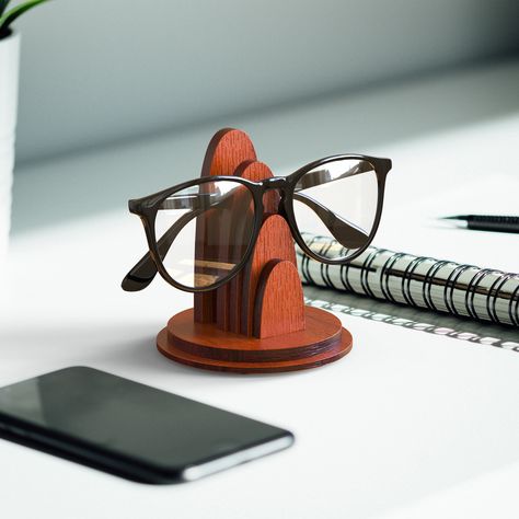 "Wooden glasses holder for desk. FEATURES Eyeglasses stand for desk made with birch wood. It accomodates your specs easily when It's folded and gives you the chance to display your glasses in a stylish way. DESIGN With its sculpture like aesthetic, It's designed not only to do its function but also to be displayed to show your taste and complete the work environment, even when it's not in use. With the color options you can choose the best variation to match up with your desktop. MATERIAL Birch Wood Glasses Holder, Clay Glasses Holder, Eye Glasses Stand, Passive Amplifier, Wooden Glasses Holder, Eyeglass Stand, Rose Gold Glasses, Wood Phone Holder, Sunglasses Stand