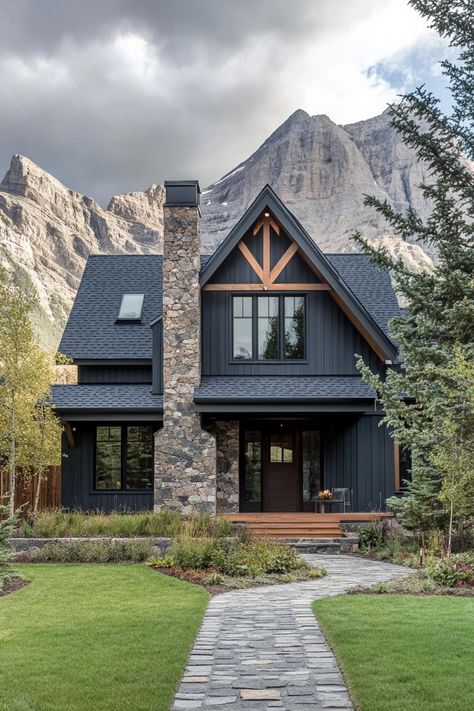 Check out the trending exterior colors for modern mountain houses that blend harmoniously with natural surroundings while adding a touch of contemporary flair. Black Mountain House Exterior, Rustic Exterior Color Schemes, Mountain Lake House Exterior, Dark Exterior Wood Accents, Dark House Wood Accents, Airbnb Mountain House, Exterior Options For House, House Rock Exterior, Farmhouse With Rock Exterior