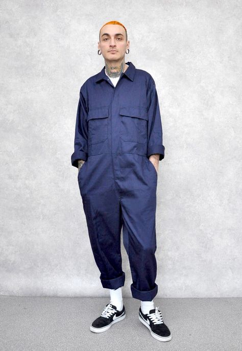 "Navy blue boiler suit, the perfect staple piece to make a statement this autumn winter, dress up with shoes, or wear casually around the waist with a perfect white tee, features two side pockets two chest pockets with flaps, Stud front fastening and lastly elasticated side. Item has been rolled up for styling purposes hem an be unrolled.  SIZING AND CARE Model wears a size medium model size is medium chest size 40\" This item comes slightly oversized, as worn on our model. Made from a mix of po Mens Boiler Suit, Boiler Suit Men, Jumpsuit Outfit Men, Boilersuit Outfit, Boiler Suit Outfit, Coverall Outfit, Scifi Ideas, White Tees Outfit, Overall Men