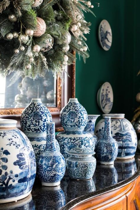 Frontgate A wreath hung in front of the mirror and a collection of blue and white Chinese porcelain is a pefect way to decorate a dining room sideboard for the holidays. Blue And White Vases, Chinoiserie Christmas, Sideboards Living Room, Chinoiserie Decorating, White Ginger Jars, Blue And White Chinoiserie, Blue White Decor, Blue And White Vase, White Christmas Decor