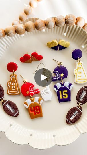 45 reactions · 5 comments | Football starts this week!! 🏈👏🏻  And so does this Collection ❤️ I’m a little behind on getting these out, but better late than never! 😆  Choose your favorite style of earrings, favorite number, and team colors and personalize it to your liking ❤️💙🧡  What’s your football team? Comment below! ⬇️   Football Collection coming Wednesday to the shop! Save the date! • • • • • • • •  #polymerclaycreations #polymerclayjewelry #fallfashion  #clayjewelry #fallstyle  #handmadeearrings #hypoallergenic  #sports #fallvibes #fall  #earringsoftheday #football #footballjewelry🏈 #footballgames #footballseason #nfl   #love #polymerclay #autumnvibes #smallbusiness #etsy #falljewelry #footballearrings #footballjewelry | Clovers and Clay | ROKKA · Game Day Football Polymer Clay Earrings, Football Clay Earrings, Football Jewelry, Magnet Ideas, Favorite Number, Football Earrings, Polymer Clay Figures, Better Late Than Never, Diy Jewelry Inspiration