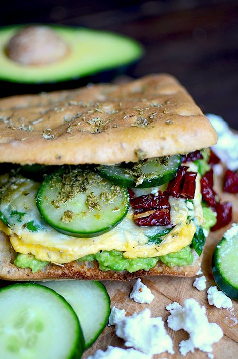 This recipe beats a McMuffin any day! A scrambled egg with spinach and cheese, avocado smash, cukes, sun dried tomatoes, and pesto on rosemary foccacia make the ultimate breakfast sandwich! Rosemary Foccacia, Avocado Smash, Egg Sandwich Recipe, Best Egg Salad Recipe, Mediterranean Breakfast, Healthy Sandwich Recipes, Breakfast Sandwich Recipes, Mediterranean Diet Plan, Overnight Oat